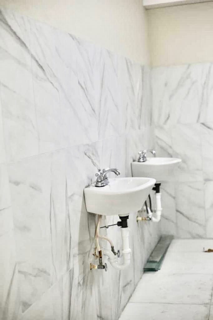 Marble sink installation in UNAH dormitory bathroom