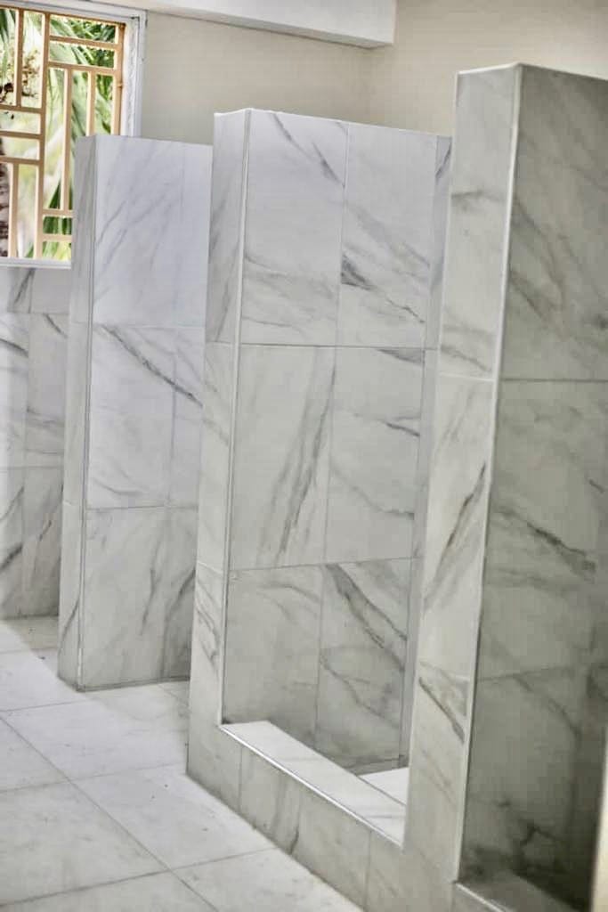 Marble shower stall partitions being built in UNAH dormitory