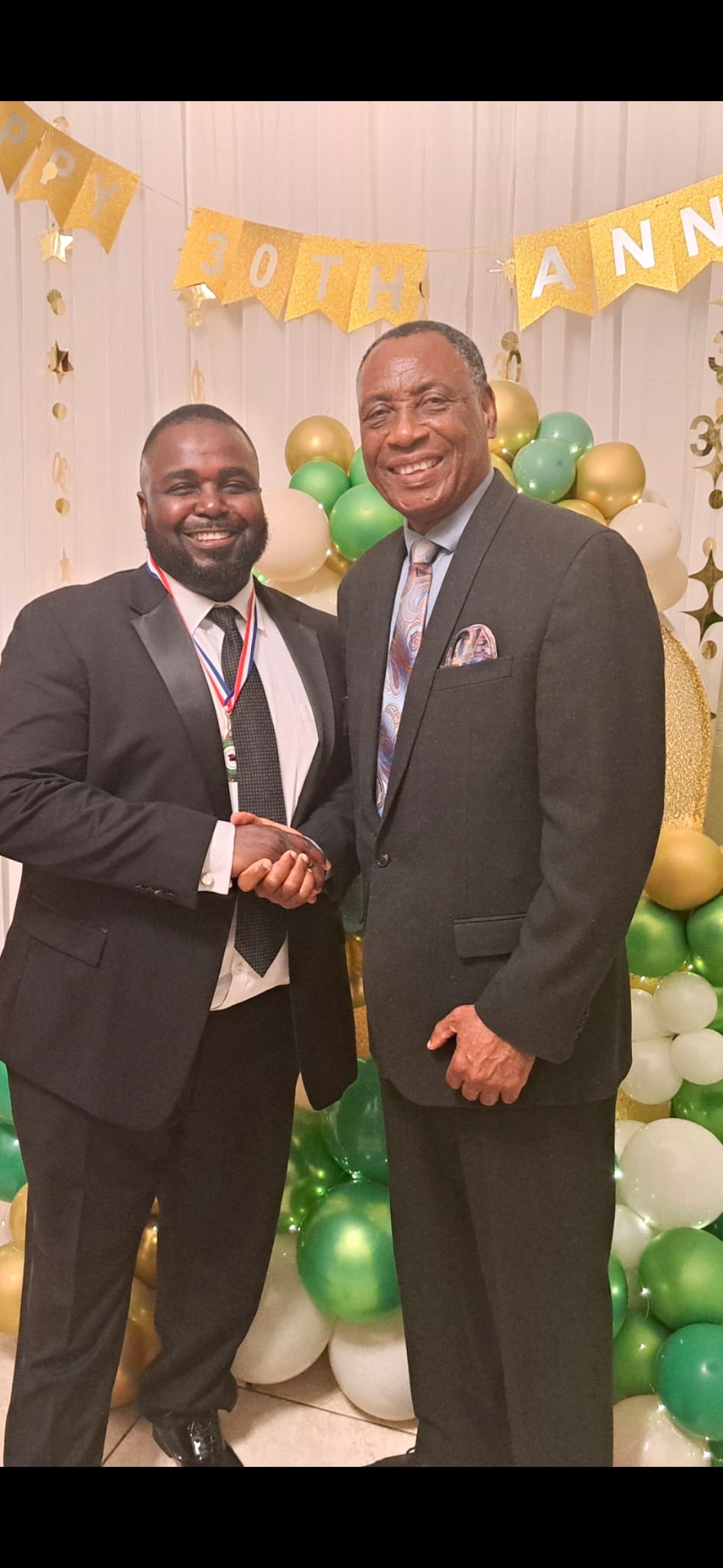 Dr. Saint Louis with a CALUNAH member at the 30th Anniversary celebration